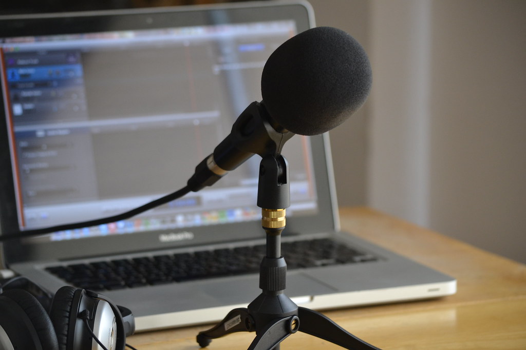 Podcast Microphone with laptop in background